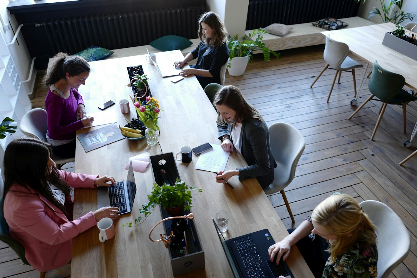 Overhead view of the office with the team working at a shared table