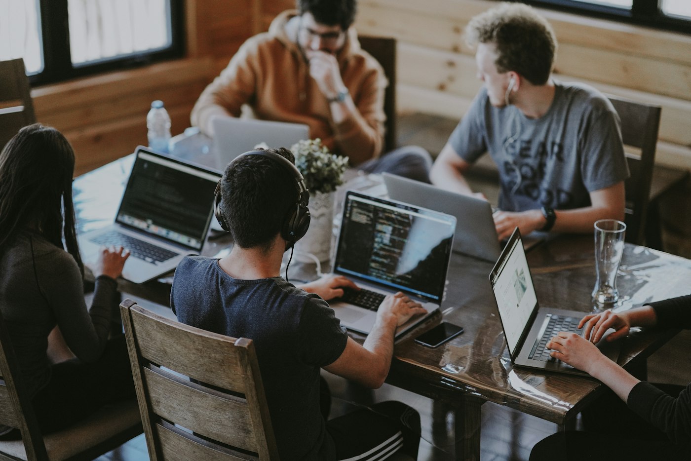 5Skill Solutions team working on laptops on an AI project